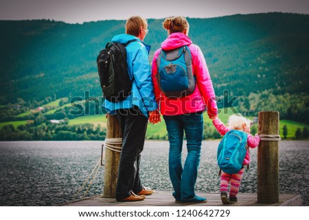family with small baby girl travel hiking in nature