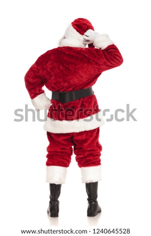 back view of pensive santa claus standing on white background, full length picture