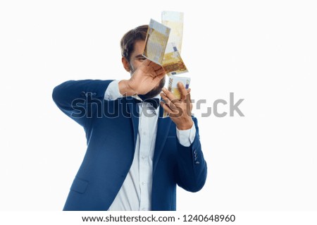 a rich man throws money on a light background                    