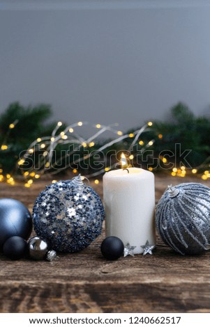 Elegant gray silver christmas scene with glowing candle