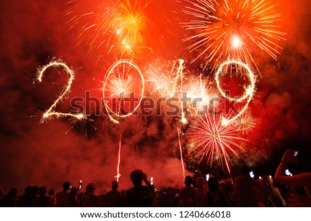 2019 Happy New Year written with Sparkle firework on black background, Crowd of Party people.