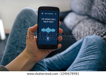 Girl holding smart phone with voice assistant concept on screen. All screen content is designed by me Royalty-Free Stock Photo #1240678981