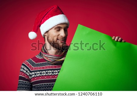 happy man in a cap looks at the green mockup                              