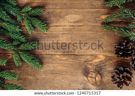 Christmas composition gift pine cones fir branches wooden brown background. Flat lay, top view, copy space Green tree wooden eco-pine