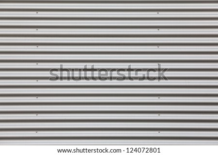 Wide shot of silver corrugated metal with bolts Royalty-Free Stock Photo #124072801
