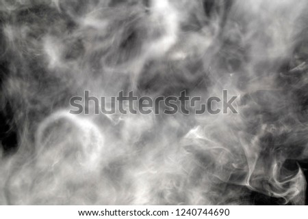 photo of developing smoke from a cigarette on a black background