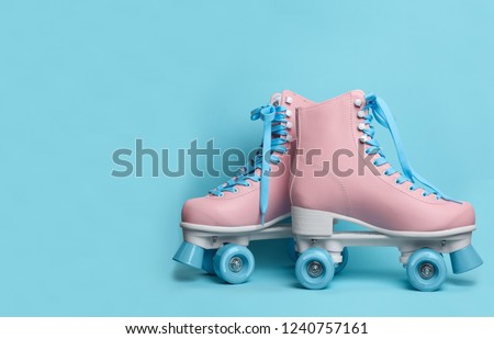 Pair of stylish quad roller skates on color background. Space for text