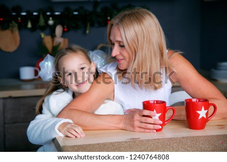 The blonde hair woman in studio with daughter