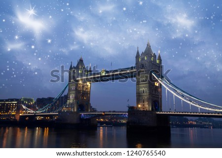 Holiday in London - Christmas background with the London bridge under snowy sky