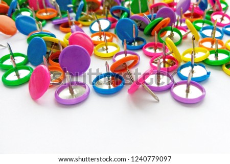 Colorful stationary, back to school, office, business and education concept. School and office supplies paper clips, pins on white background. Close up photography