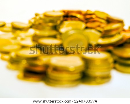 Blurred or disfocused background. Scattering of gold euro coins. A great number of coins symbolize wealth, richness, income and profit. Close up shot. Pile or lots of euro cents. Toned picture
