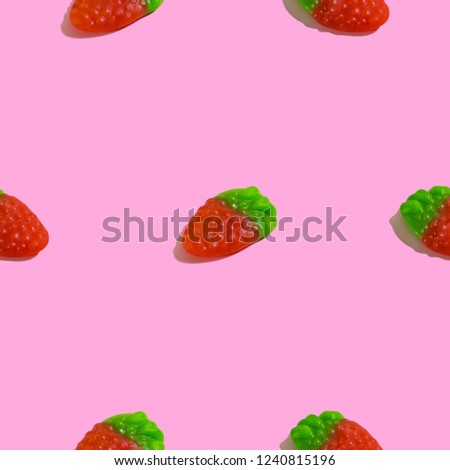 Creative seamless pattern with jelly raspberry on pink background. Candy abstract background.
