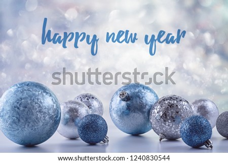  Happy New Year invitations, cards with blue and silver decoration. Christmas balls in snow.  Copy space.