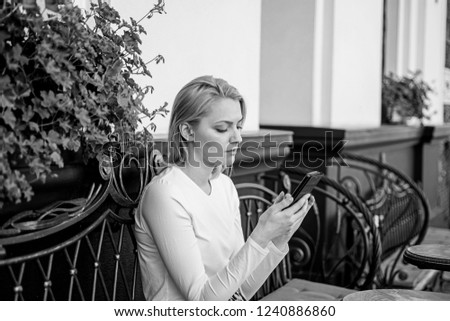 Keep in touch. Woman calm face texting smartphone cafe terrace urban background. Lady texting message friend white spend time in cafe. Girl communicating with friend using smartphone.