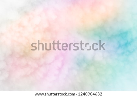 Fluffy white blurred feather like sky clouds on abstract neon pastels of rainbow patchwork  background - Colorful diversity od Fashion color trends Spring Summer 2019. Soft focus