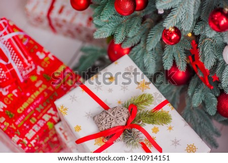 Gift box under the Christmas tree. Red balls