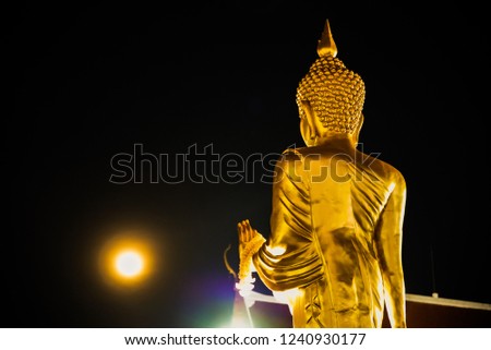 Meditation hand with spiritual of Statue buddha against full moon and circle of light.