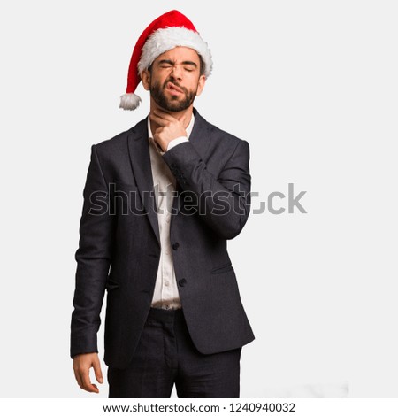 Young business man wearing santa hat coughing, sick due a virus or infection