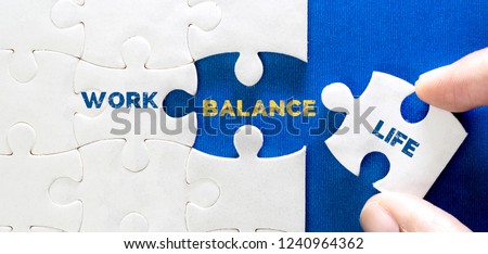 Close up piece of white jigsaw puzzle with word of WORK LIFE BALANCE , concept of wellbeing and balanced lifestyle Royalty-Free Stock Photo #1240964362