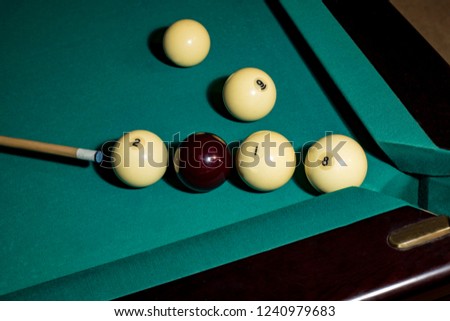 Billiard balls and cue.  One hit and ball number eight is in the pocket.  New Year concept.  Changing of the year.