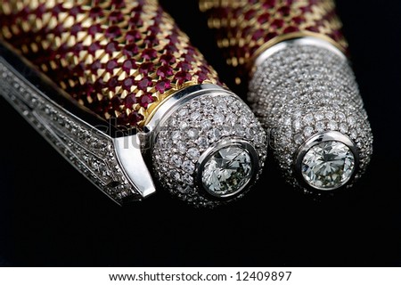 Pen with diamonds and ruby isolated on black background