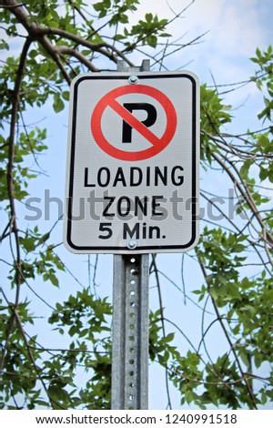 A no parking, five minute loading zone sign