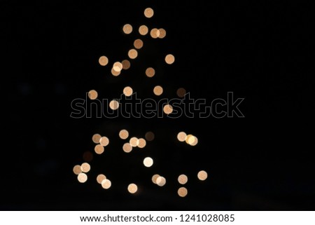 christmas tree light silhouette on black