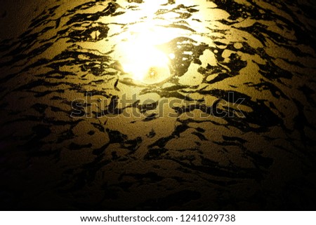 the texture of color on water and orange light