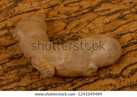 Ginger root over the wooden background
