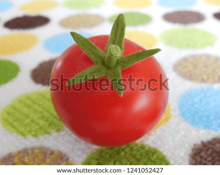 Blurred tomato on the background of a decorative napkin.