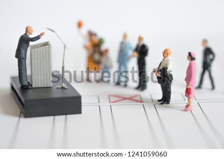 Miniature people : politician or party candidate in excited speech persuades to vote for him. Election debates or press conference concept