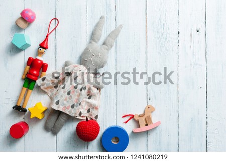 classic toys on faded white wooden frame background
