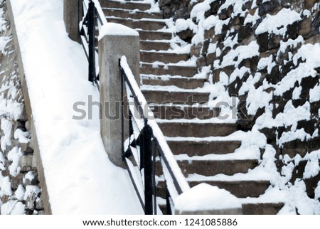 fragment of snowbound stone staircase, detail of a winter urban landscape