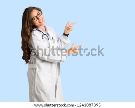 Full body young doctor woman pointing to the side with finger