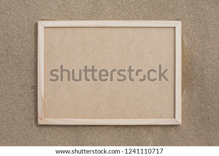Wooden frame with sand background