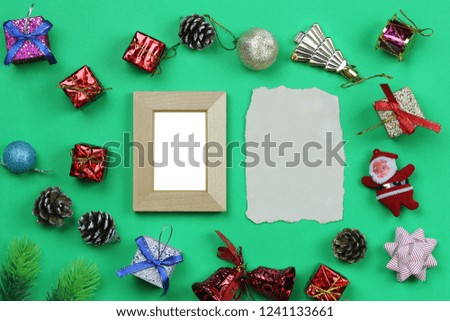 Christmas decoration equipment and photo frame on green paper art background with copy space for your design.