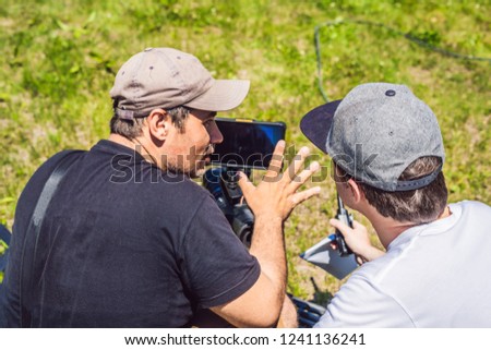 a cameraman operator discuss the shooting process with a director and dp