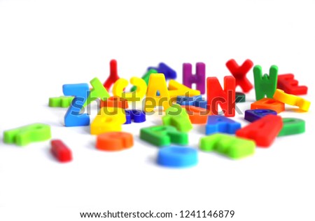 funny colorful letters on white standing and laying around