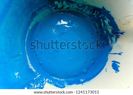 bright dark blue paint in a bucket