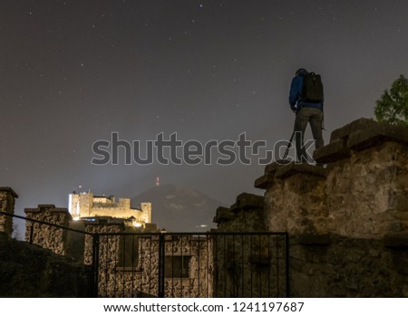 a photographer taking a long exposure shot of castle hohen salzburg in salzburg