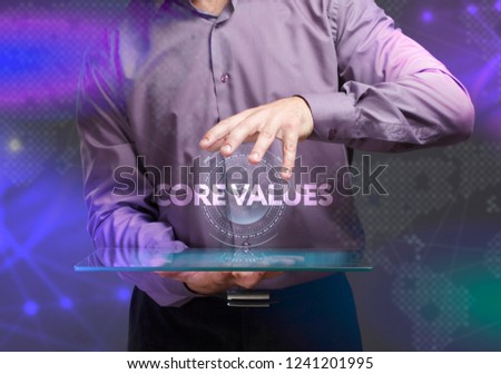 The concept of business, technology, the Internet and the network. A young entrepreneur working on a virtual screen of the future and sees the inscription: Core values
