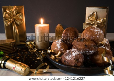 dish oliebollen, oil dumpling or fritter, champagne and gift box, for Dutch New Year's Eve