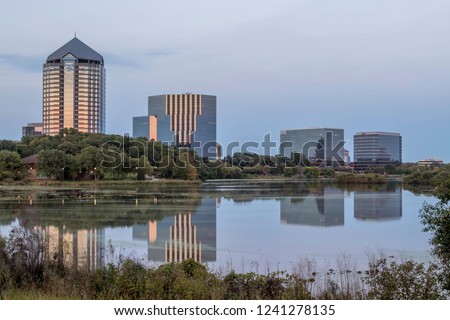 A Wide Angle Shot of a Bloomington Office Block Reflecting in Lake Normandale during an Early Fall Twilight  Royalty-Free Stock Photo #1241278135