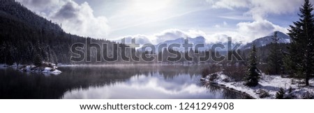 A beautiful panoramic view of Gold Creek Pond in Washington State on a snowy winter morning. 