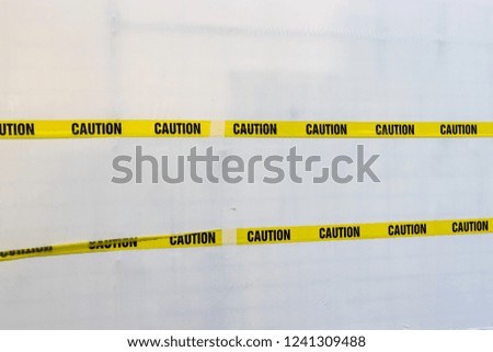 Yellow Plastic Caution Tape Crossed Isolated on White Background.