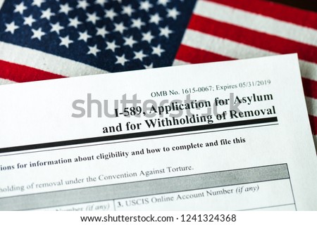 Application for asylum to USA concept with application form and USA flag on mexican serape Royalty-Free Stock Photo #1241324368