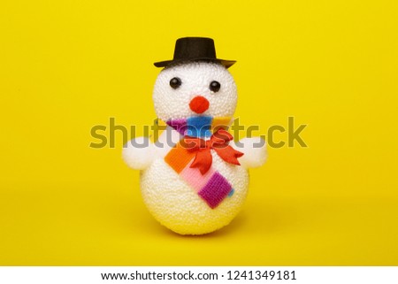 Christmas, New Year's snowman on a yellow background. Christmas background
