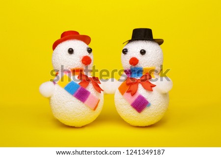 Christmas, New Year's snowman on a yellow background. Christmas background
