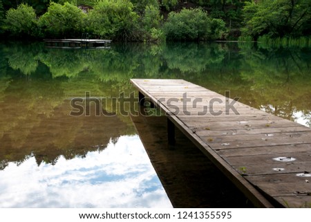 Pier by the river Royalty-Free Stock Photo #1241355595
