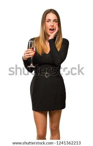 Woman with champagne celebrating new year 2019 surprised and shocked while looking right on isolated white background